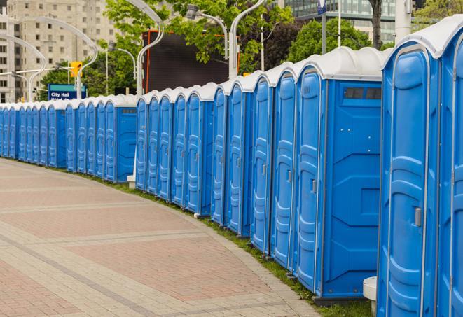 a line of portable restrooms at a sporting event, providing athletes and spectators with clean and accessible facilities in Mazeppa MN